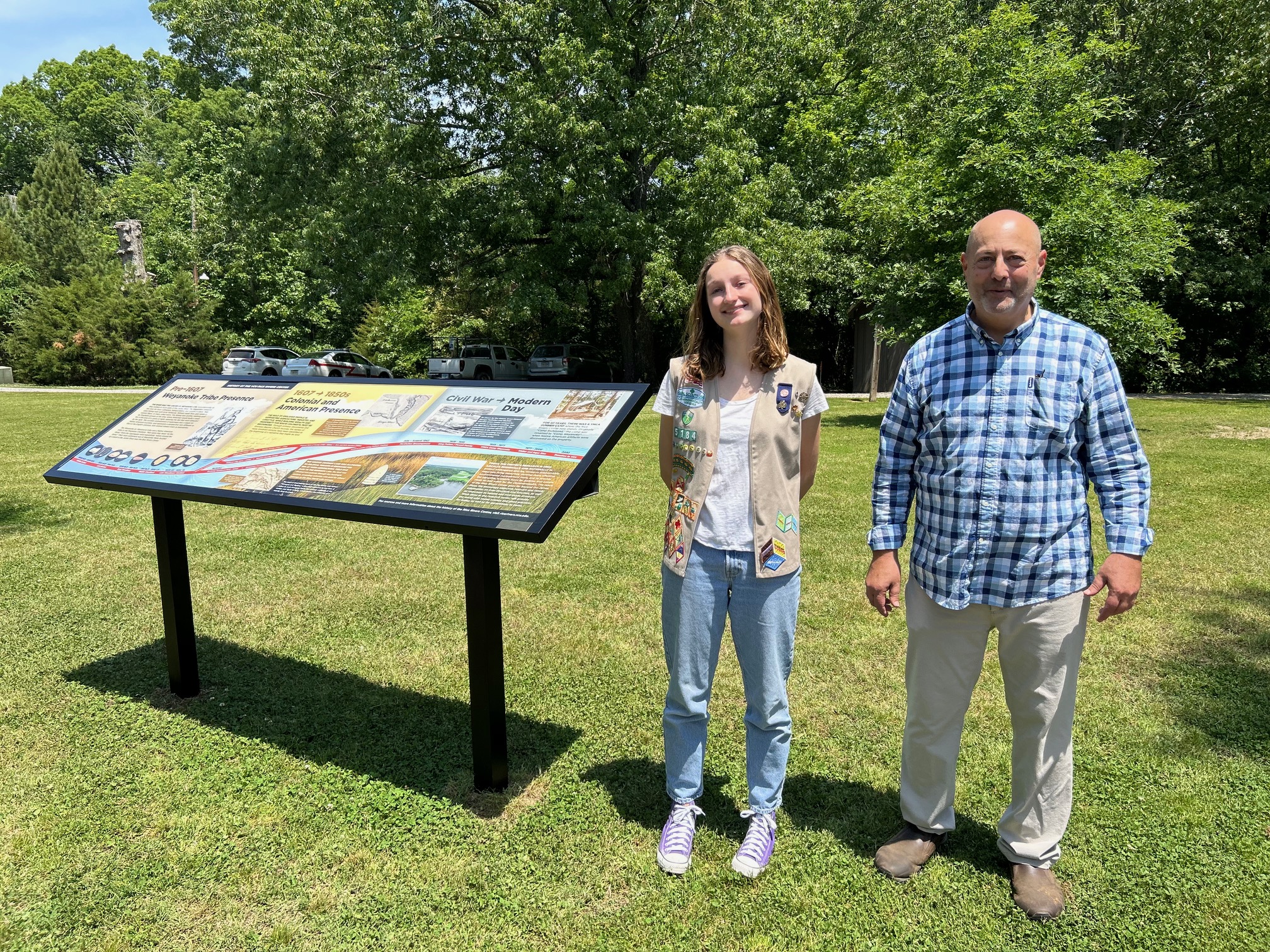 Amelia Johnson and Rice Rivers Center director Greg Garman stand next to an educational sign