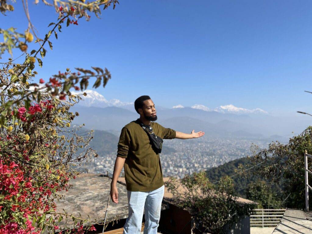 Donté Jackson standing on a hill overlooking a city